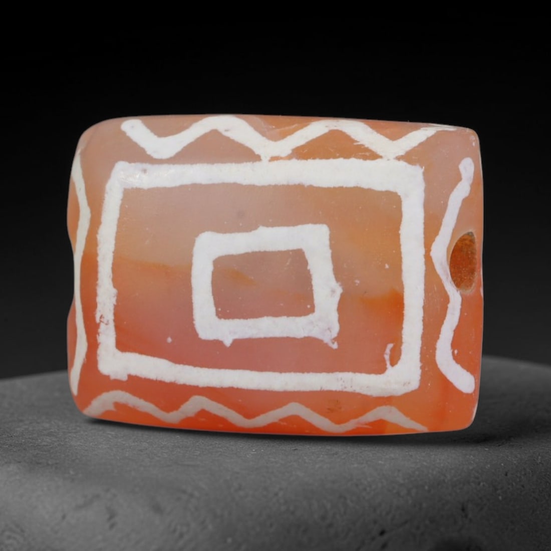 Antique Sino-Himalayan Region Etched Carnelian Bead, 9EH: Antique etched carnelian bead originating from the Sino-Himalayan region. Exhibits characteristic surface patina and traditional etched white decoration. Dimensions: 16x12mm, fully pierced for suspens