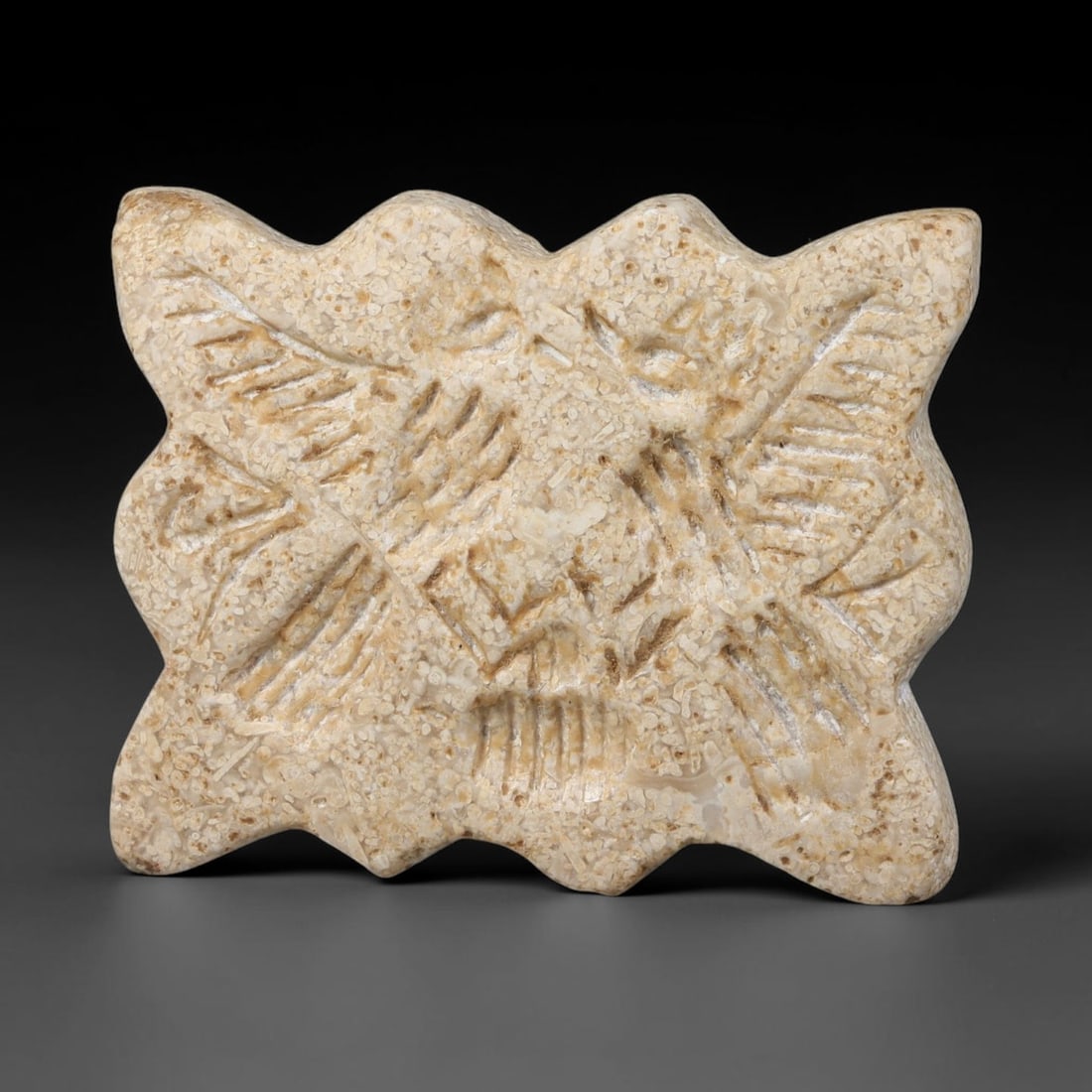 Ancient Neo-Hittite Multi-Lobed Limestone Stamp Seal (1200-800 BCE), 19EF: This multi-lobed stamp seal is carved from speckled pale limestone, originating from Iron Age Neo-Hittite cultures of Northern Syria and Eastern Anatolia. The seal face bears an intaglio scene featuri