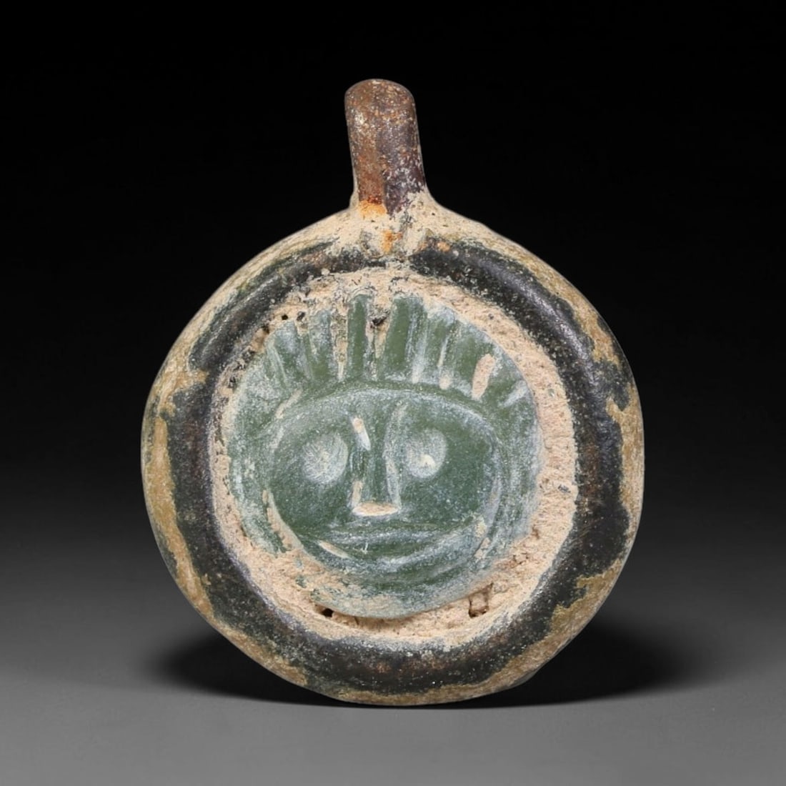 Ancient Medieval Byzantine Bronze Pendant With Stone Cameo (500-1200 CE), 61EH: This antique circular bronze pendant originates from medieval Byzantine cultural tradition, set with an inset carved stone cameo and made to serve as a wearable protective personal amulet. The bronze 