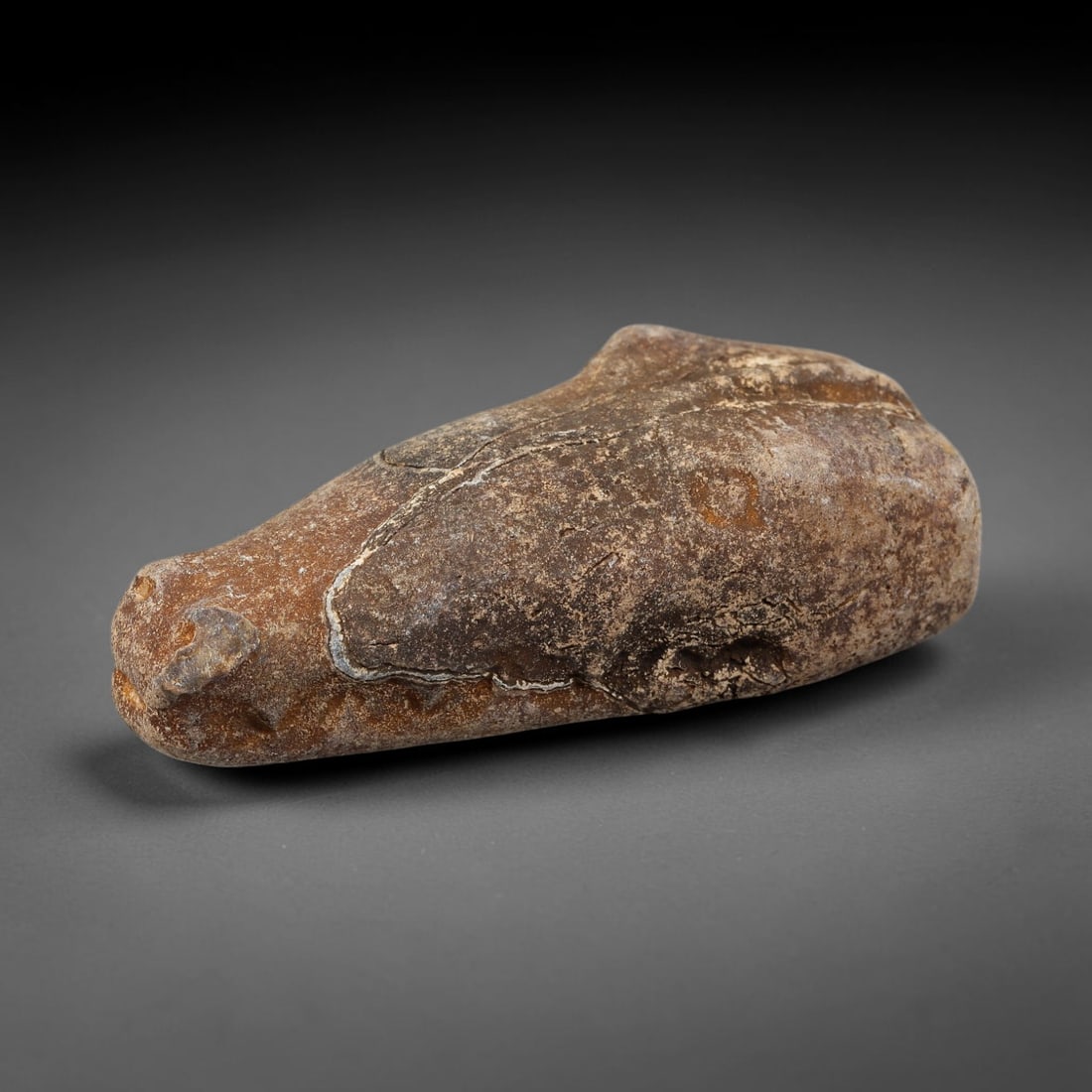 Ancient Medieval Near Eastern Stone Zoomorphic Head (600-1100 CE), 14EK: This antique stone zoomorphic head originates from medieval Near Eastern cultural tradition, created for ceremonial and talismanic function. The dense stone bears heavy agerelated patina, surface eros
