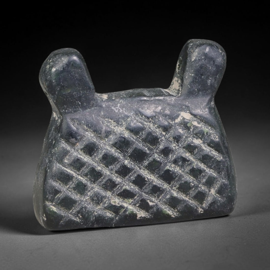Ancient Sasanian Persian Serpentine Patterned Talisman Amulet Bead (224-651 CE), 10EC: This antique non-zoomorphic talisman amulet bead carved from serpentine originates from the Sasanian Persian Empire, crafted as a protective wearable charm marked with symbolic incised ornamentation. 