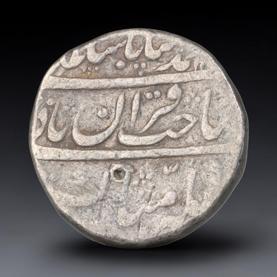 Antique Mughal Islamic Calligraphic Silver Coin (1526-1857 CE), 50EQ: This authentic silver coin originates from the Mughal Empire, struck with elegant flowing Islamic calligraphic script arranged across both obverse and reverse faces, characteristic of Mughal numismati