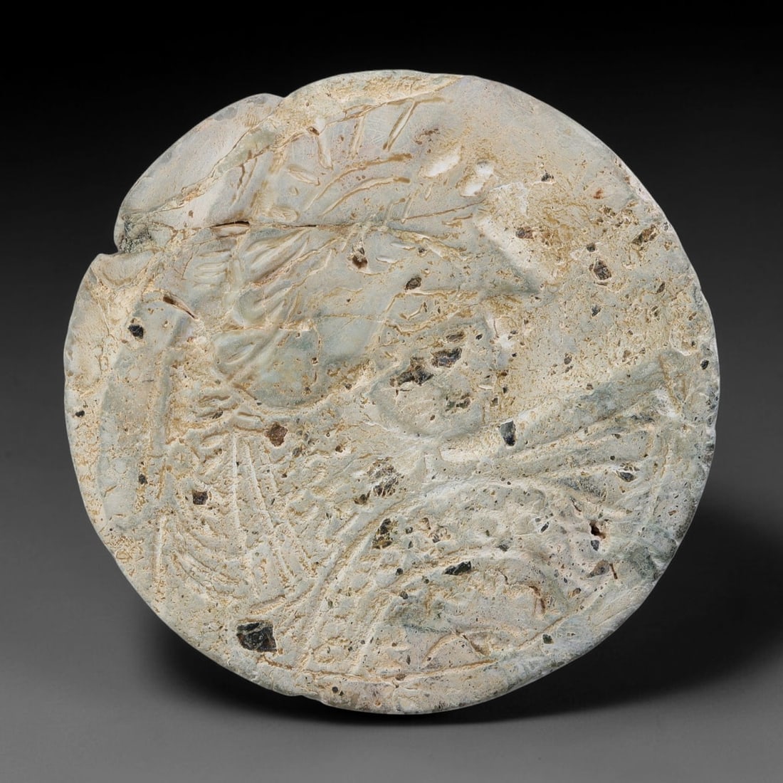Ancient Roman Republic & Imperial Roman Stone Carved Round Plaque (509 BCE-476 CE), 13AB: This weathered circular carved stone plaque originates from Roman Republic & Imperial Roman Culture, crafted as elite personal signet and decorative grave relics for Roman provincial funerary and dome