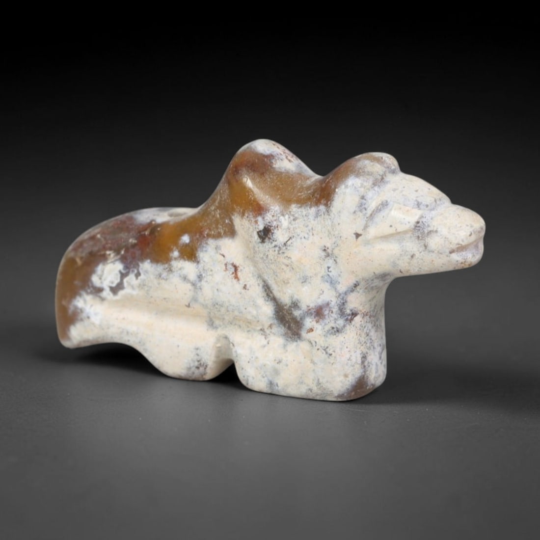 Ancient Bactrian Agate Bactrian Camel Effigy Amulet (c.200-200 BCE), 94EQ: Hand-carved from translucent banded agate originating within ancient Bactria, Central Asia. This compact wearable talisman depicts a resting Bactrian two-humped camel, formed with streamlined minimali