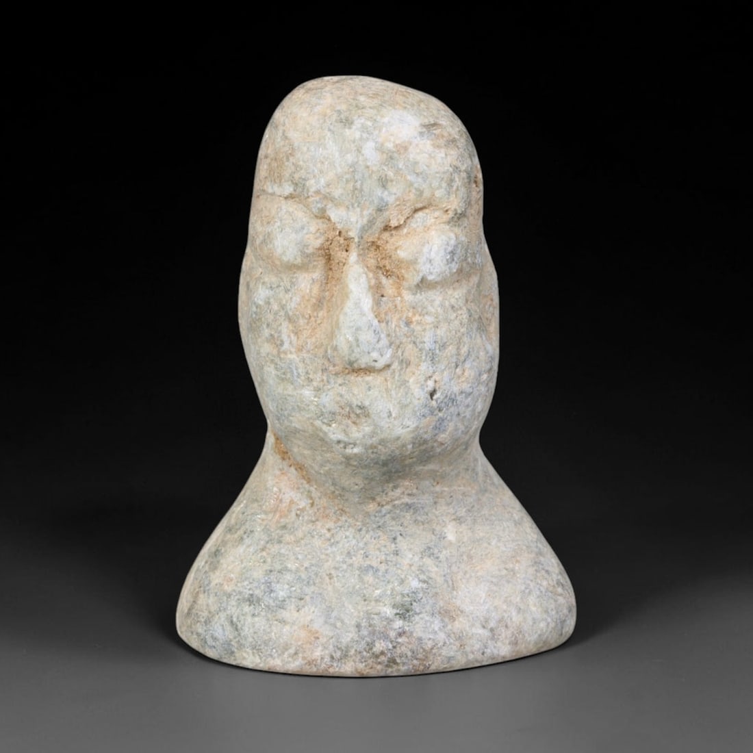 Ancient Bactrian Schist Idol Head (c.2300-1700 BCE), 66EQ: This miniature votive sculpture is carved from pale schist originating from ancient Bactrian cultural civilisation, modelled as a stylised human bust with simplified, schematic facial features typical