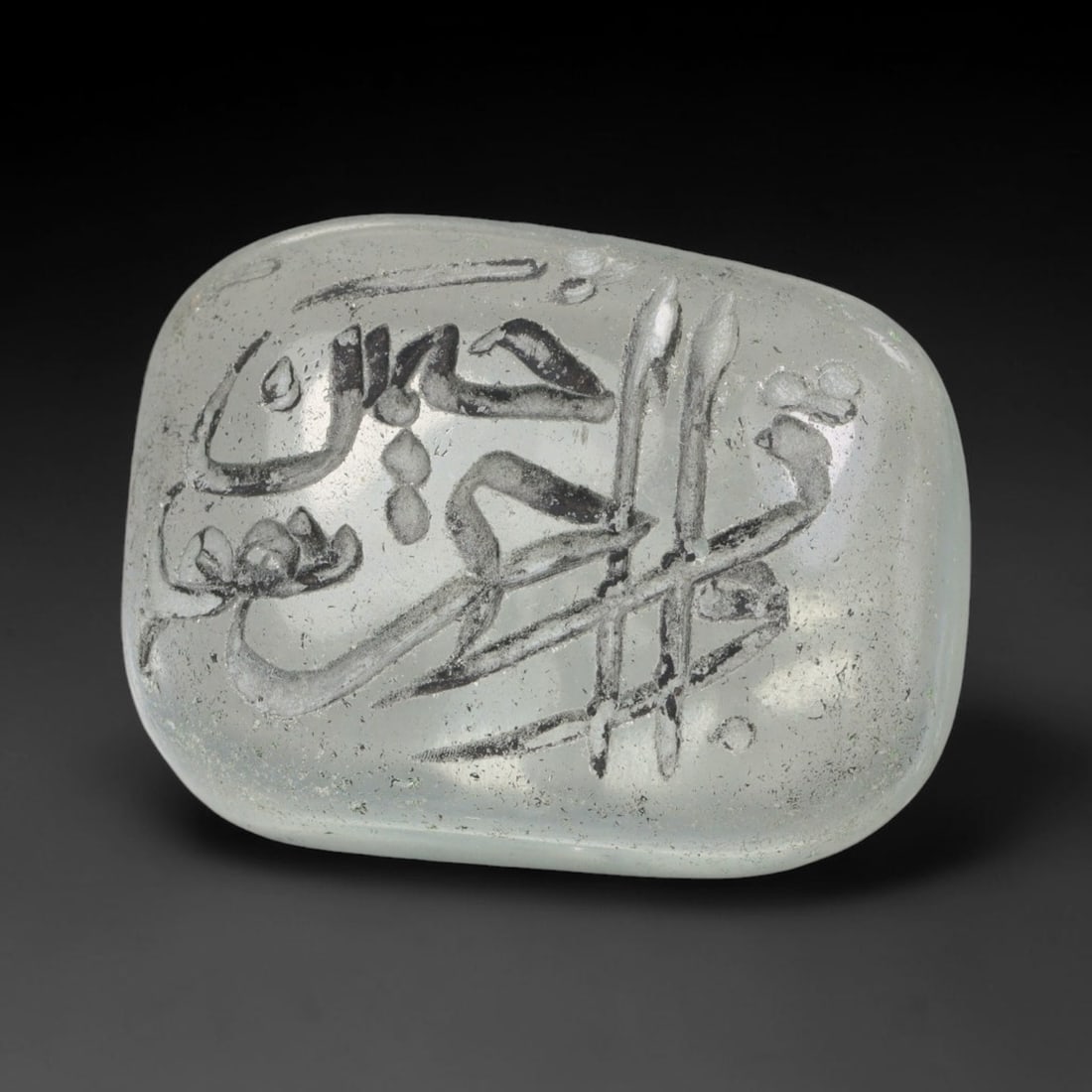 Early Vintage Islamic White Glass Calligraphic Script Intaglio Seal Cabochon (Post 1900 CE), 84BX: This early vintage glass intaglio seal cabochon draws from enduring Islamic seal-making traditions, formed from translucent pale glass with a smoothly rounded polished surface. The face features caref