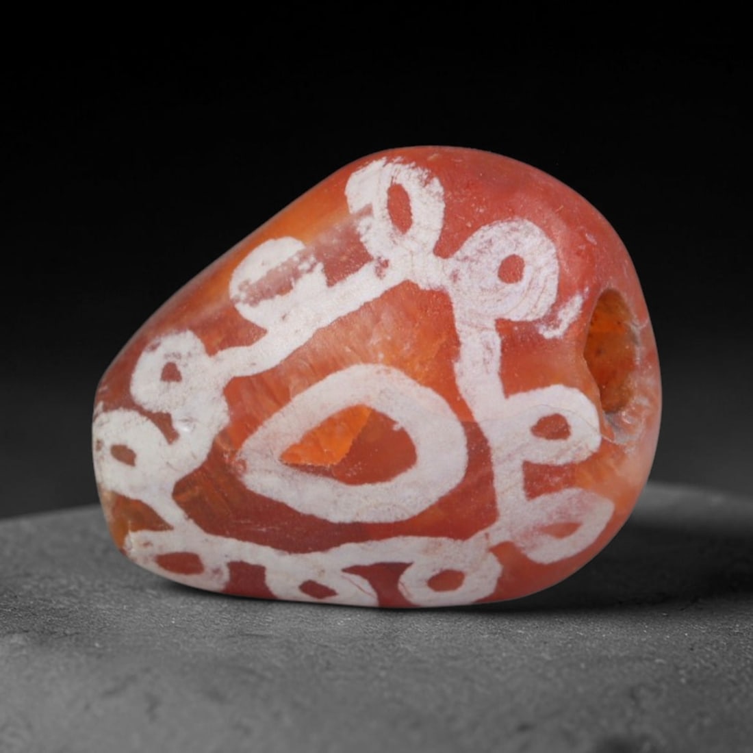 Antique Sino-Himalayan Region Etched Carnelian Bead, 78EG: Antique etched carnelian bead originating from the Sino-Himalayan region. Exhibits characteristic surface patina and traditional etched white decoration. Dimensions: 12x11mm, fully pierced for suspens