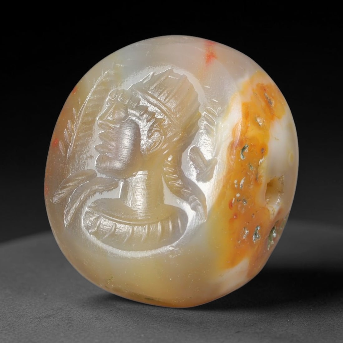 Ancient Sasanian Persian Banded Agate Royal Bust Intaglio Stamp Seal (224-651 CE), 76EQ: This domed wearable stamp seal is carved from naturally banded agate originating from the Sasanian Persian Empire. The oval intaglio surface features a finely engraved profile bust of a crowned noble 