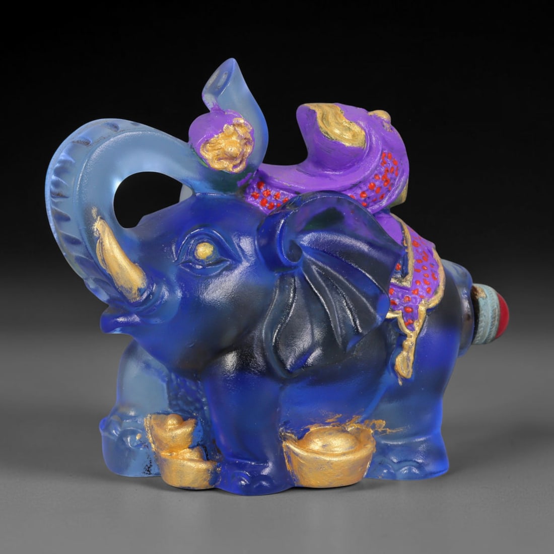 Vintage Chinese Liuli Glass Snuff Bottle - Elephant Figurine, 44AS: This snuff bottle is cast from translucent deep blue liuli glass, formed as a seated elephant with gilded tusks and ingots at its feet. The elephant's back supports a hand-painted purple treasure moti