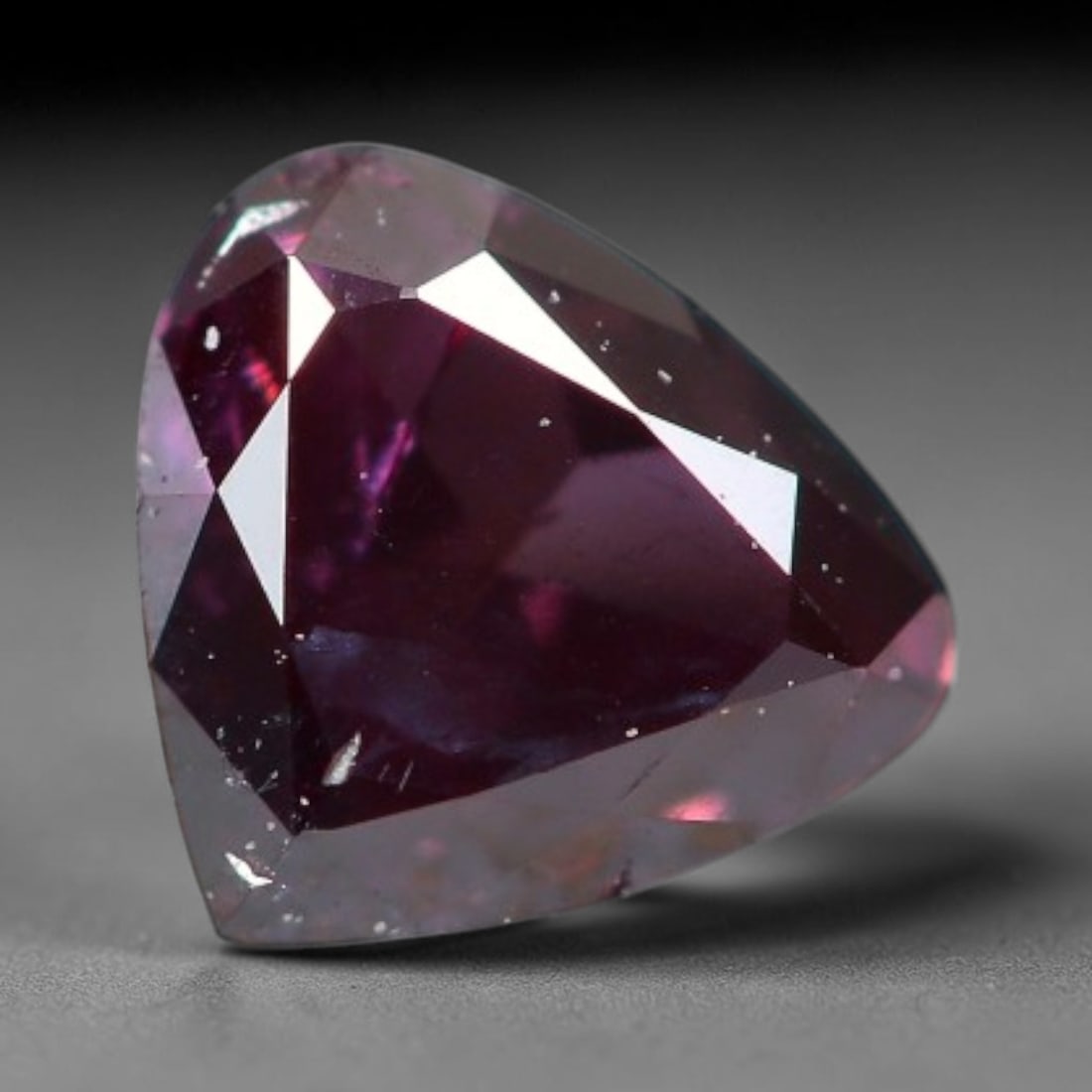 0.22ct Natural Fancy Pinkish Purple Diamond Loose Gemstone, 21BG: This polished natural diamond displays rich pinkish-purple body saturation, with subtle fine microscopic mineral specks distributed within its crystal interior, measured at calibrated dimensions of 4.
