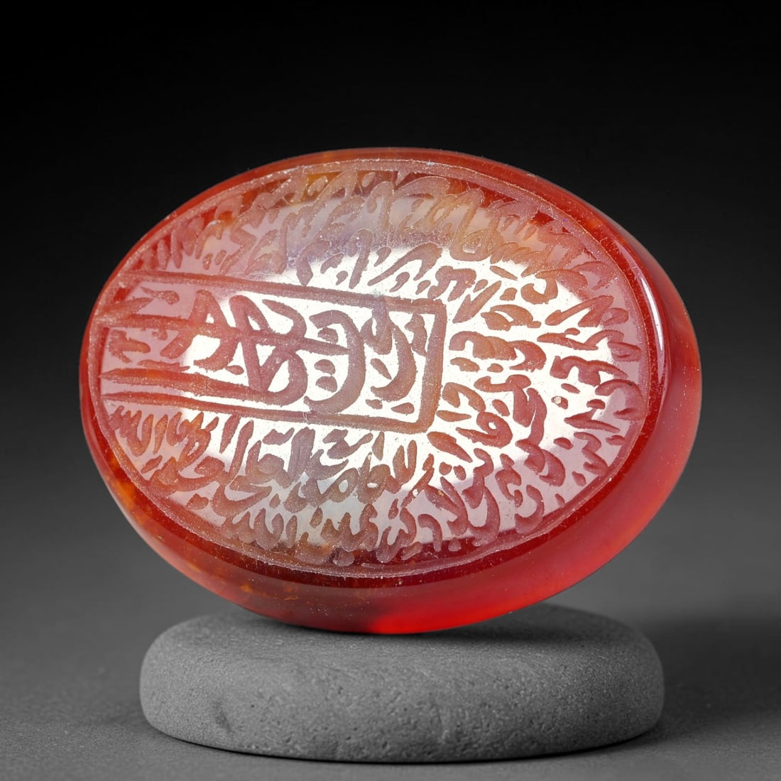 Ancient Medieval Mughal Islamic Carnelian Agate Calligraphic Script Talisman 1526-1857 CE, 45ES: Polished rich-toned carnelian agate cabochon, finely engraved with divided panels of Islamic calligraphic intaglio inscriptions. Deep crisp engraving features segmenting incised lines organizing the s