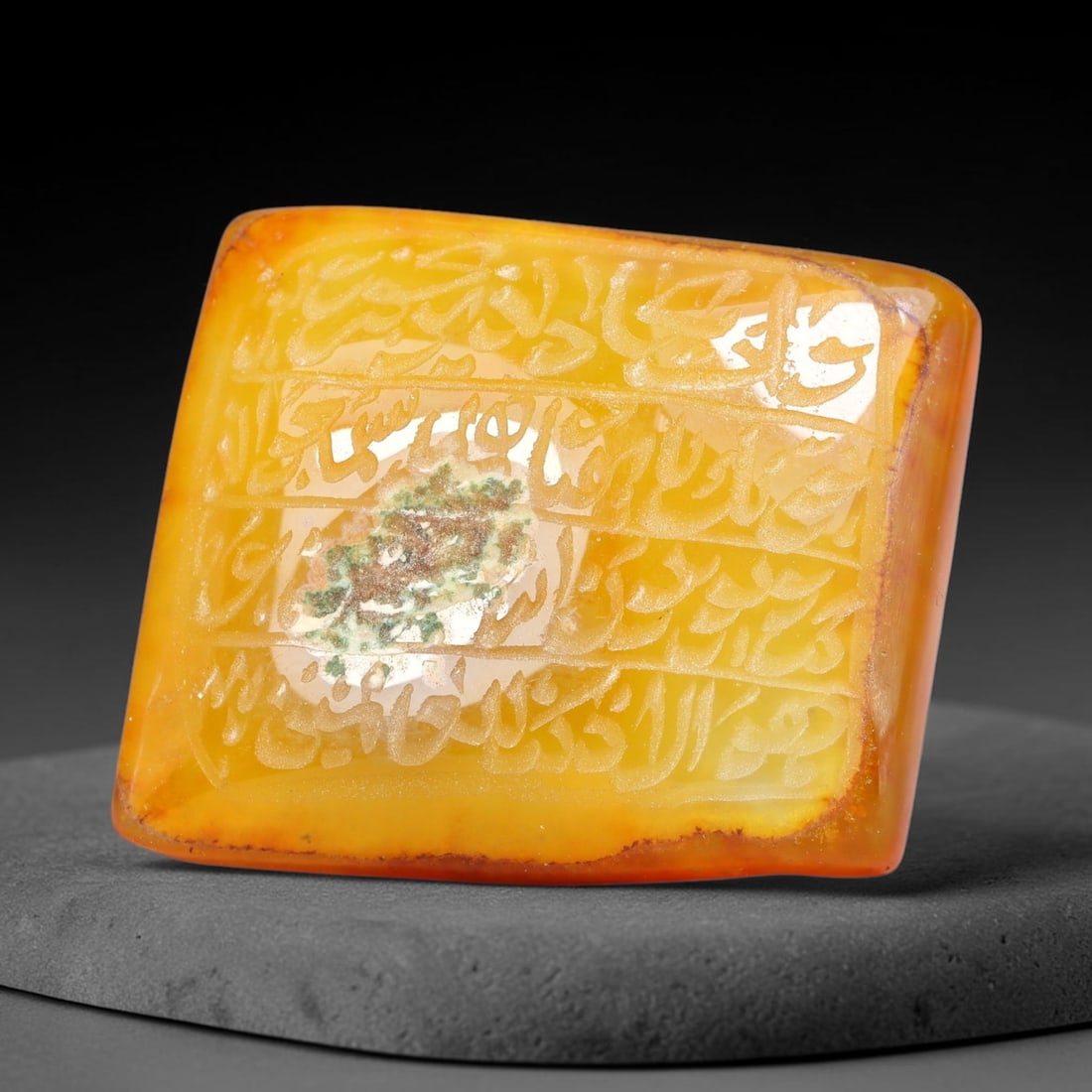 Ancient Medieval Mughal Islamic Carnelian Agate Calligraphic Script Talisman 1526-1857 CE, 63ES: Polished rich-toned carnelian agate cabochon, finely engraved with divided panels of Islamic calligraphic intaglio inscriptions. Deep crisp engraving features segmenting incised lines organizing the s