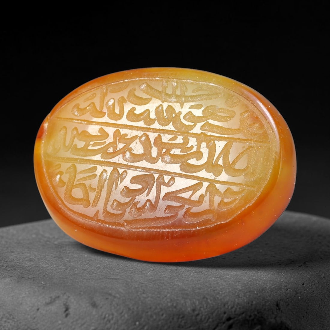 Ancient Medieval Mughal Islamic Carnelian Agate Calligraphic Script Talisman 1526-1857 CE, 64ES: Polished rich-toned carnelian agate cabochon, finely engraved with divided panels of Islamic calligraphic intaglio inscriptions. Deep crisp engraving features segmenting incised lines organizing the s