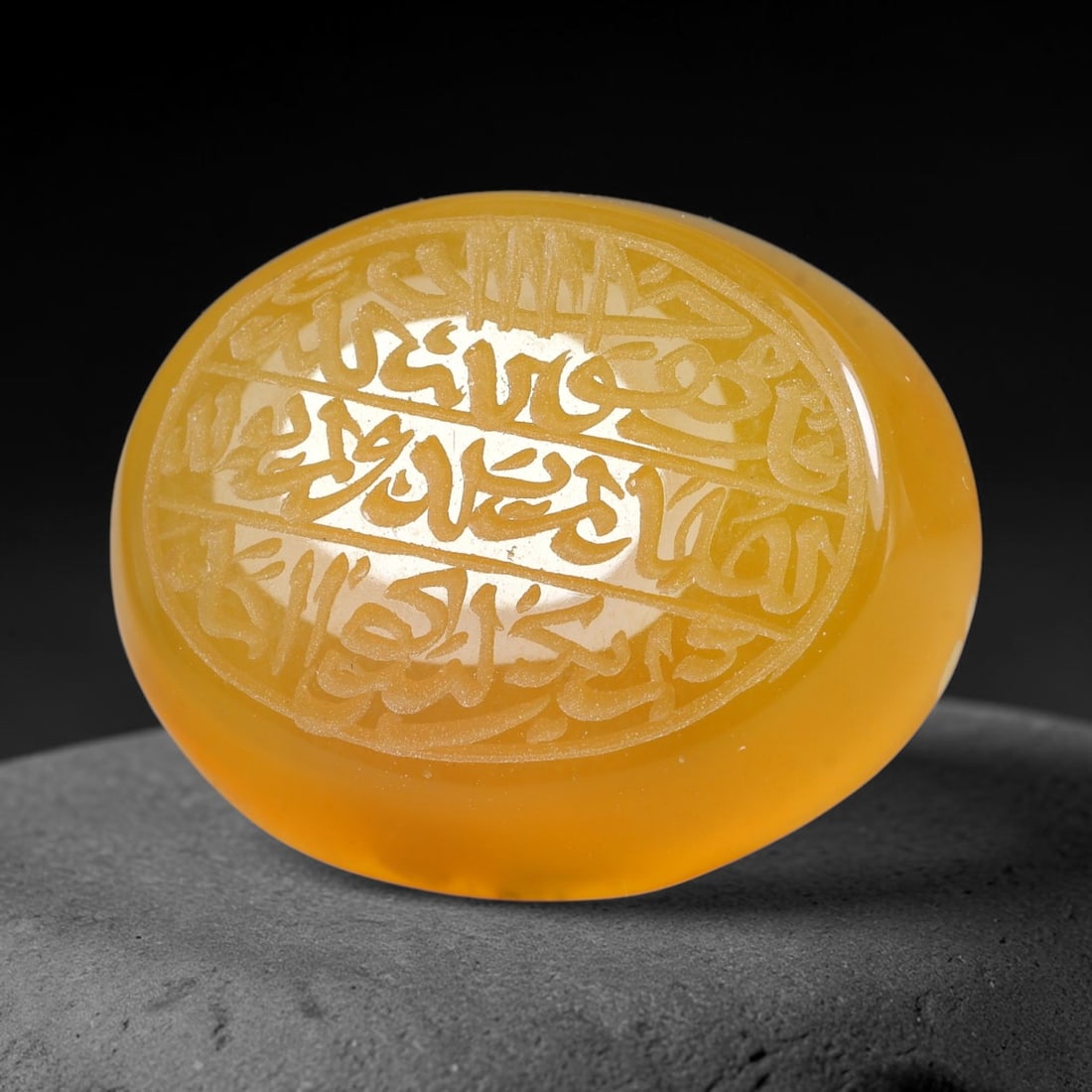 Ancient Medieval Mughal Islamic Carnelian Agate Calligraphic Script Talisman 1526-1857 CE, 41ES: Polished rich-toned carnelian agate cabochon, finely engraved with divided panels of Islamic calligraphic intaglio inscriptions. Deep crisp engraving features segmenting incised lines organizing the s