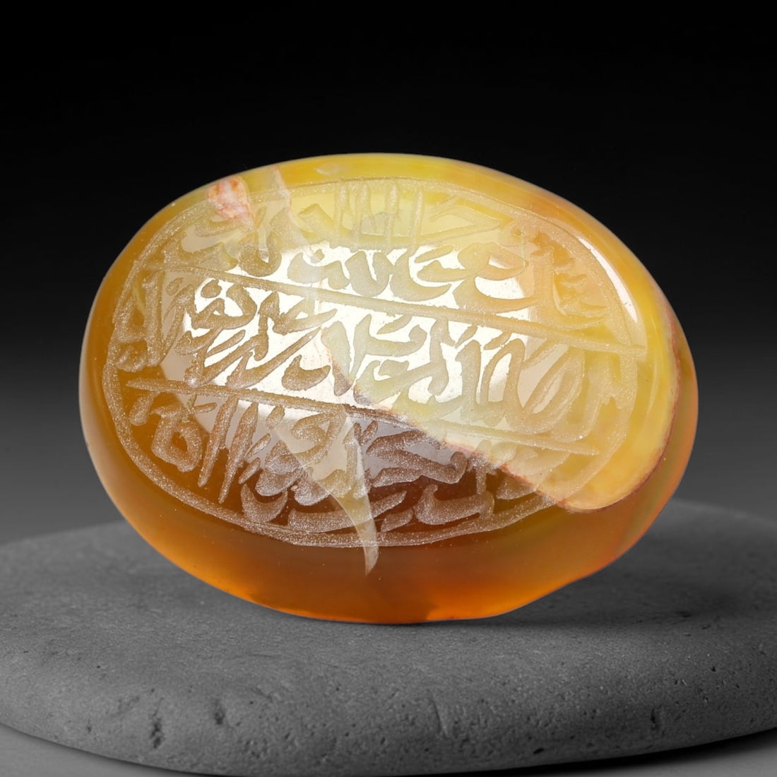 Ancient Medieval Mughal Islamic Carnelian Agate Calligraphic Script Talisman 1526-1857 CE, 62ES: Polished rich-toned carnelian agate cabochon, finely engraved with divided panels of Islamic calligraphic intaglio inscriptions. Deep crisp engraving features segmenting incised lines organizing the s