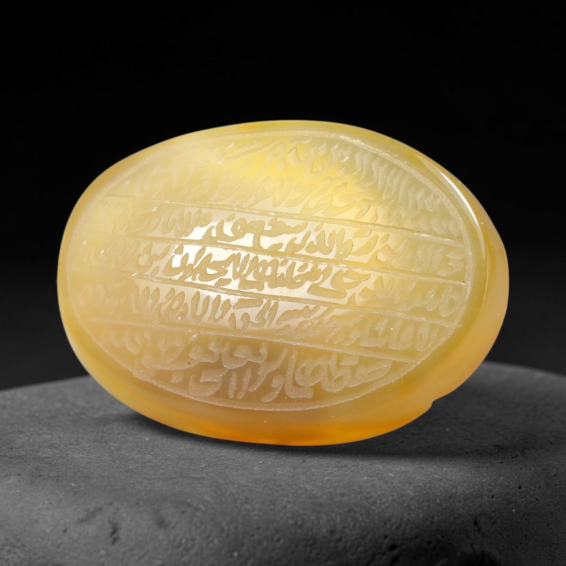 Ancient Medieval Mughal Islamic Carnelian Agate Calligraphic Script Talisman 1526-1857 CE, 65ES: Polished rich-toned carnelian agate cabochon, finely engraved with divided panels of Islamic calligraphic intaglio inscriptions. Deep crisp engraving features segmenting incised lines organizing the s