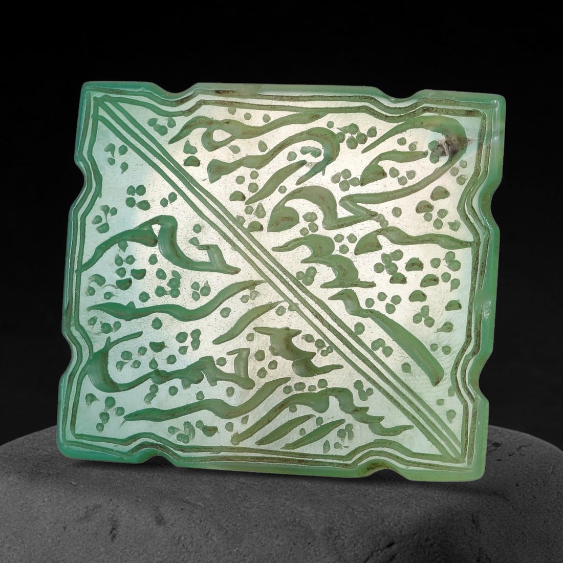 Ancient Medieval Mughal Islamic Onyx Calligraphic Script Talisman Plaque 1526-1857 CE, 74ES: Fashioned from green-toned onyx, this shaped rectangular talisman plaque bears finely engraved calligraphic script divided by a diagonal incised line, bordered with decorative scalloped framing. Surfa