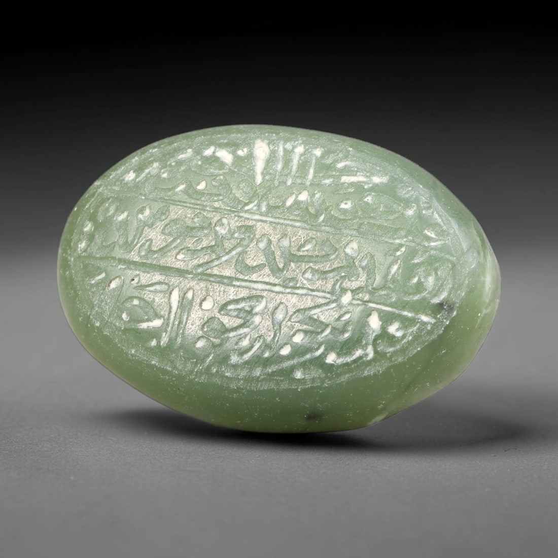 Ancient Medieval Mughal Islamic Carnelian Agate Calligraphic Script Talisman 1526-1857 CE, 37ES: Polished rich-toned carnelian agate cabochon, finely engraved with divided panels of Islamic calligraphic intaglio inscriptions. Deep crisp engraving features segmenting incised lines organizing the s