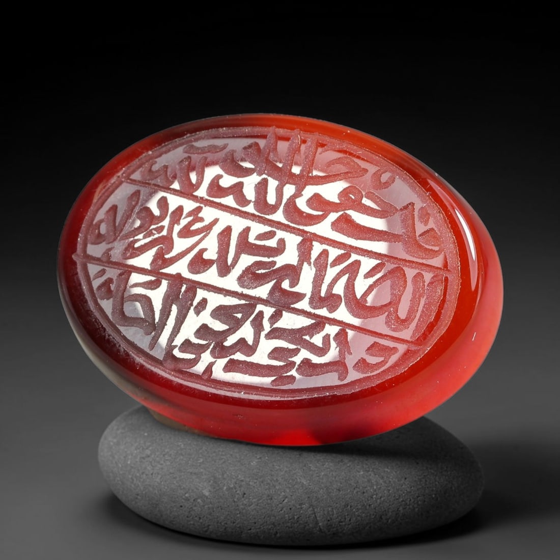Ancient Medieval Mughal Islamic Carnelian Agate Calligraphic Script Talisman 1526-1857 CE, 44ES: Polished rich-toned carnelian agate cabochon, finely engraved with divided panels of Islamic calligraphic intaglio inscriptions. Deep crisp engraving features segmenting incised lines organizing the s