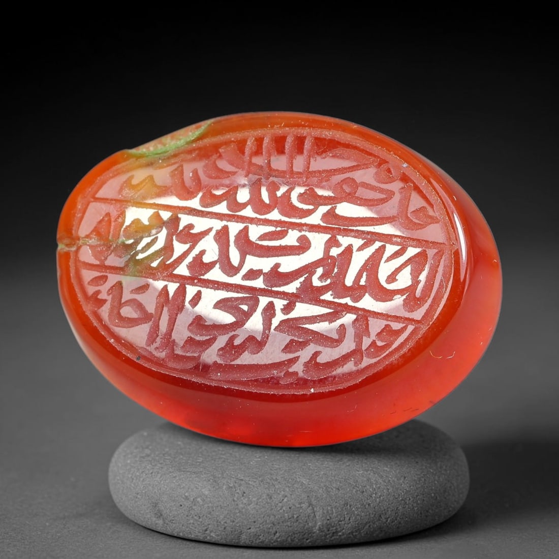 Ancient Medieval Mughal Islamic Carnelian Agate Calligraphic Script Talisman 1526-1857 CE, 46ES: Polished rich-toned carnelian agate cabochon, finely engraved with divided panels of Islamic calligraphic intaglio inscriptions. Deep crisp engraving features segmenting incised lines organizing the s