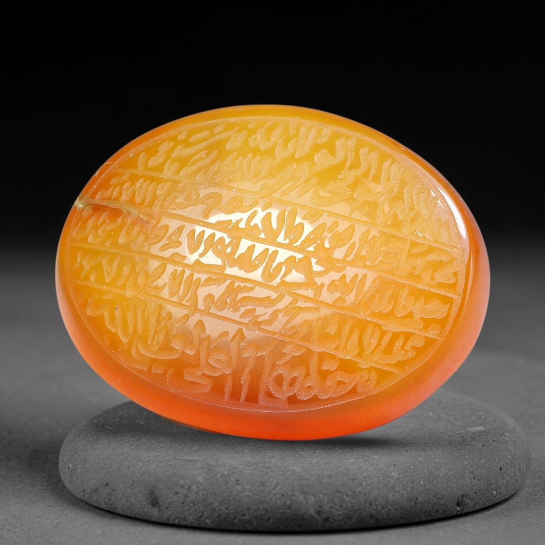 Ancient Medieval Mughal Islamic Carnelian Agate Calligraphic Script Talisman 1526-1857 CE, 29ES: Polished rich-toned carnelian agate cabochon, finely engraved with divided panels of Islamic calligraphic intaglio inscriptions. Deep crisp engraving features segmenting incised lines organizing the s