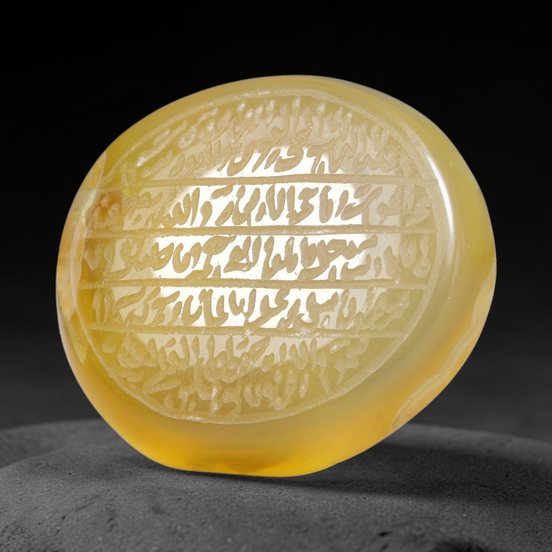 Ancient Medieval Mughal Islamic Carnelian Agate Calligraphic Script Talisman 1526-1857 CE, 49ES: Polished rich-toned carnelian agate cabochon, finely engraved with divided panels of Islamic calligraphic intaglio inscriptions. Deep crisp engraving features segmenting incised lines organizing the s