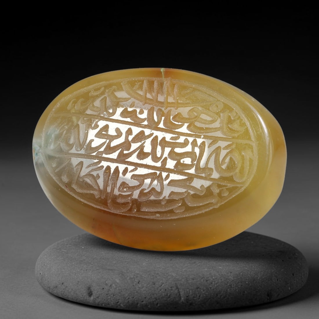 Ancient Medieval Mughal Islamic Carnelian Agate Calligraphic Script Talisman 1526-1857 CE, 32ES: Polished rich-toned carnelian agate cabochon, finely engraved with divided panels of Islamic calligraphic intaglio inscriptions. Deep crisp engraving features segmenting incised lines organizing the s