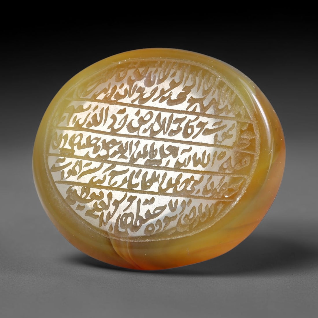 Ancient Medieval Mughal Islamic Carnelian Agate Calligraphic Script Talisman 1526-1857 CE, 33ES: Polished rich-toned carnelian agate cabochon, finely engraved with divided panels of Islamic calligraphic intaglio inscriptions. Deep crisp engraving features segmenting incised lines organizing the s