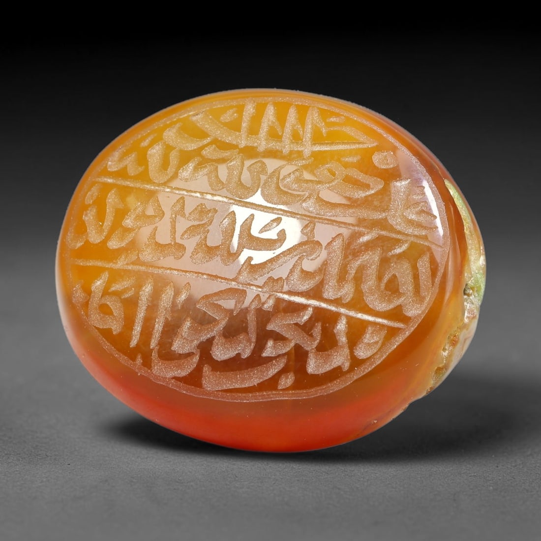 Ancient Medieval Mughal Islamic Carnelian Agate Calligraphic Script Talisman 1526-1857 CE, 21ES: Polished rich-toned carnelian agate cabochon, finely engraved with divided panels of Islamic calligraphic intaglio inscriptions. Deep crisp engraving features segmenting incised lines organizing the s