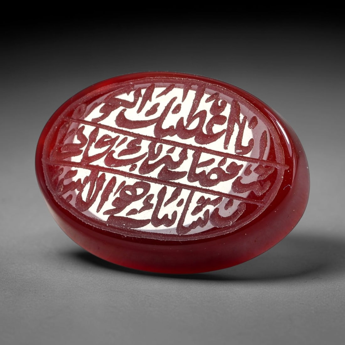 Ancient Medieval Mughal Islamic Carnelian Agate Calligraphic Script Talisman 1526-1857 CE, 31ES: Polished rich-toned carnelian agate cabochon, finely engraved with divided panels of Islamic calligraphic intaglio inscriptions. Deep crisp engraving features segmenting incised lines organizing the s