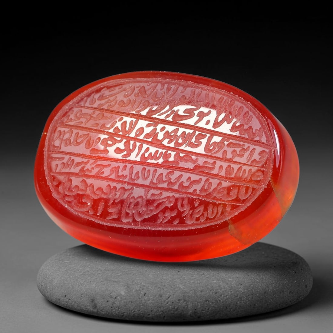 Ancient Medieval Mughal Islamic Carnelian Agate Calligraphic Script Talisman 1526-1857 CE, 55ES: Polished rich-toned carnelian agate cabochon, finely engraved with divided panels of Islamic calligraphic intaglio inscriptions. Deep crisp engraving features segmenting incised lines organizing the s