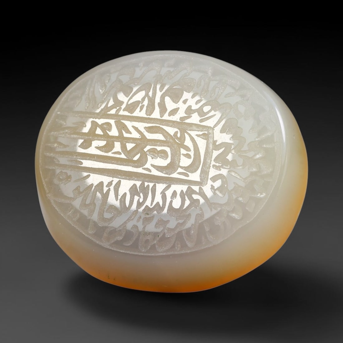 Ancient Medieval Mughal Islamic Carnelian Agate Calligraphic Script Talisman 1526-1857 CE, 25ES: Polished rich-toned carnelian agate cabochon, finely engraved with divided panels of Islamic calligraphic intaglio inscriptions. Deep crisp engraving features segmenting incised lines organizing the s