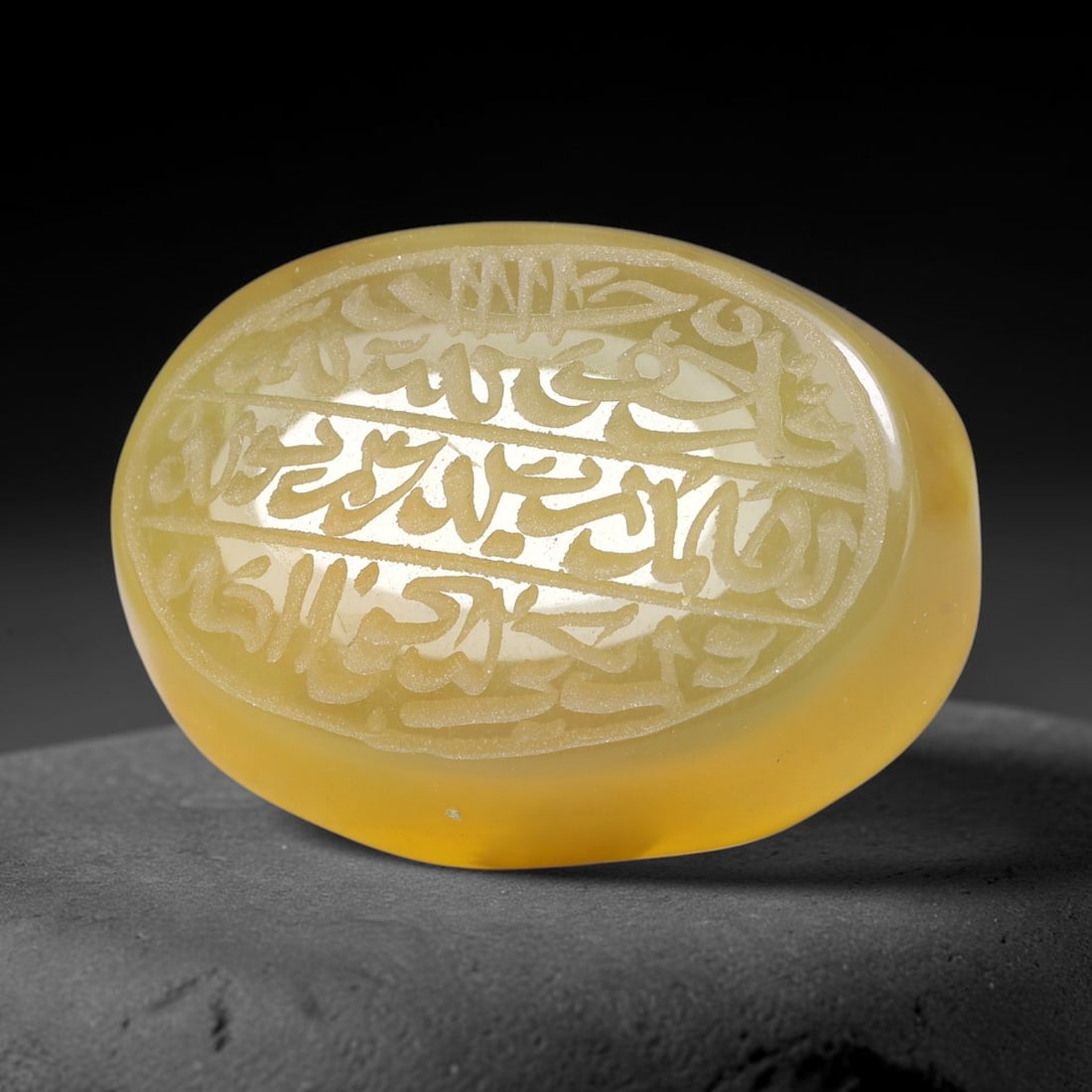 Ancient Medieval Mughal Islamic Carnelian Agate Calligraphic Script Talisman 1526-1857 CE, 38ES: Polished rich-toned carnelian agate cabochon, finely engraved with divided panels of Islamic calligraphic intaglio inscriptions. Deep crisp engraving features segmenting incised lines organizing the s