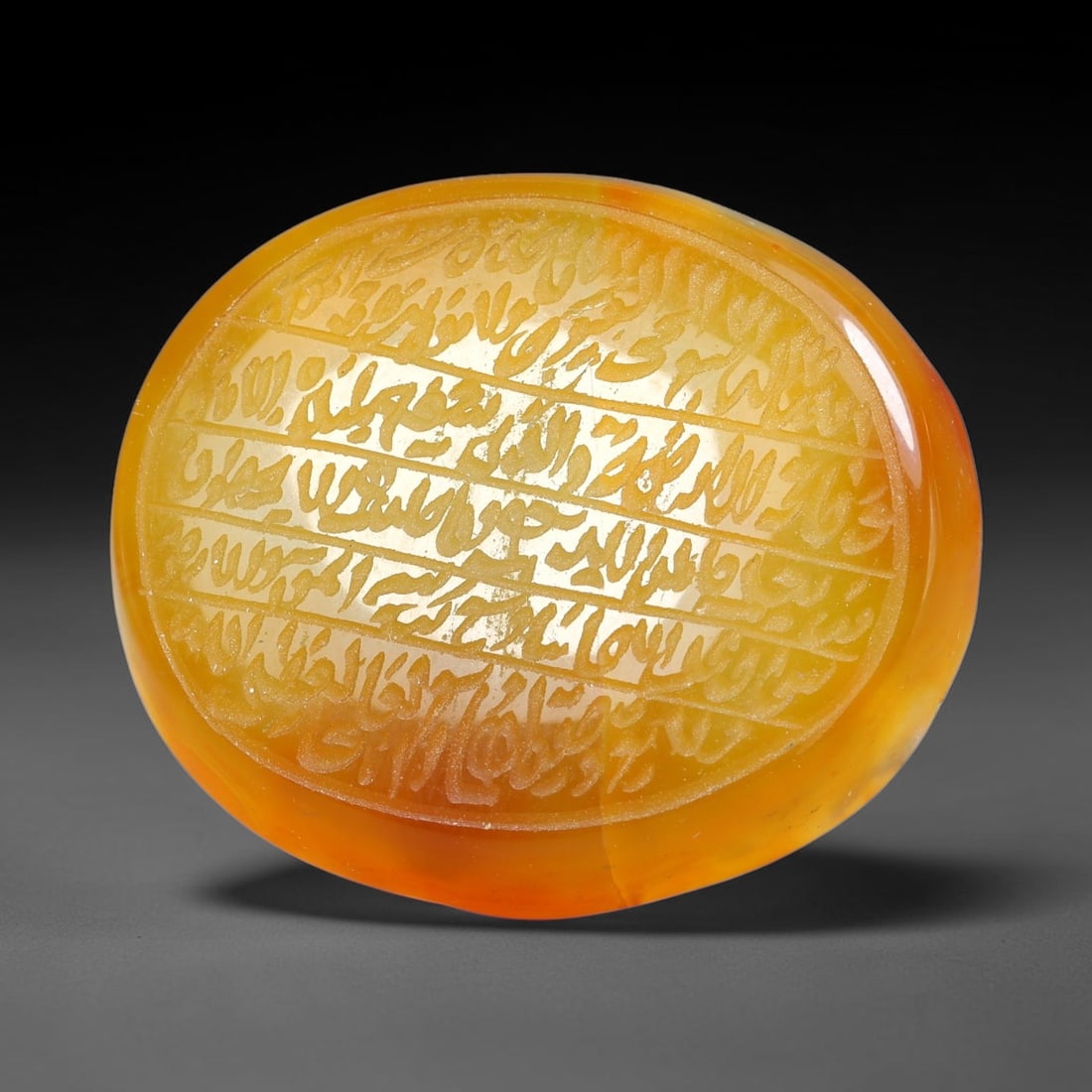 Ancient Medieval Mughal Islamic Carnelian Agate Calligraphic Script Talisman 1526-1857 CE, 61ES: Polished rich-toned carnelian agate cabochon, finely engraved with divided panels of Islamic calligraphic intaglio inscriptions. Deep crisp engraving features segmenting incised lines organizing the s