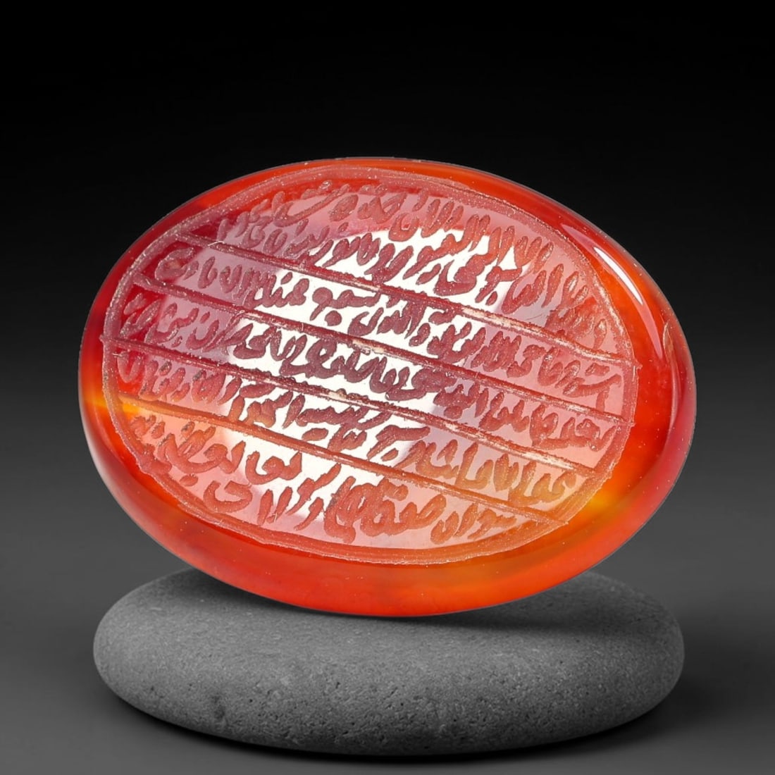 Ancient Medieval Mughal Islamic Carnelian Agate Calligraphic Script Talisman 1526-1857 CE, 57ES: Polished rich-toned carnelian agate cabochon, finely engraved with divided panels of Islamic calligraphic intaglio inscriptions. Deep crisp engraving features segmenting incised lines organizing the s