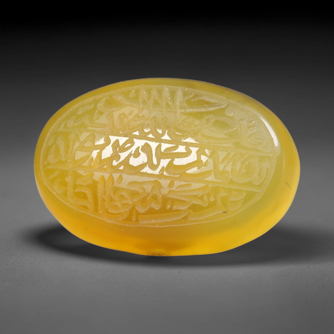 Ancient Medieval Mughal Islamic Carnelian Agate Calligraphic Script Talisman 1526-1857 CE, 52ES: Polished rich-toned carnelian agate cabochon, finely engraved with divided panels of Islamic calligraphic intaglio inscriptions. Deep crisp engraving features segmenting incised lines organizing the s