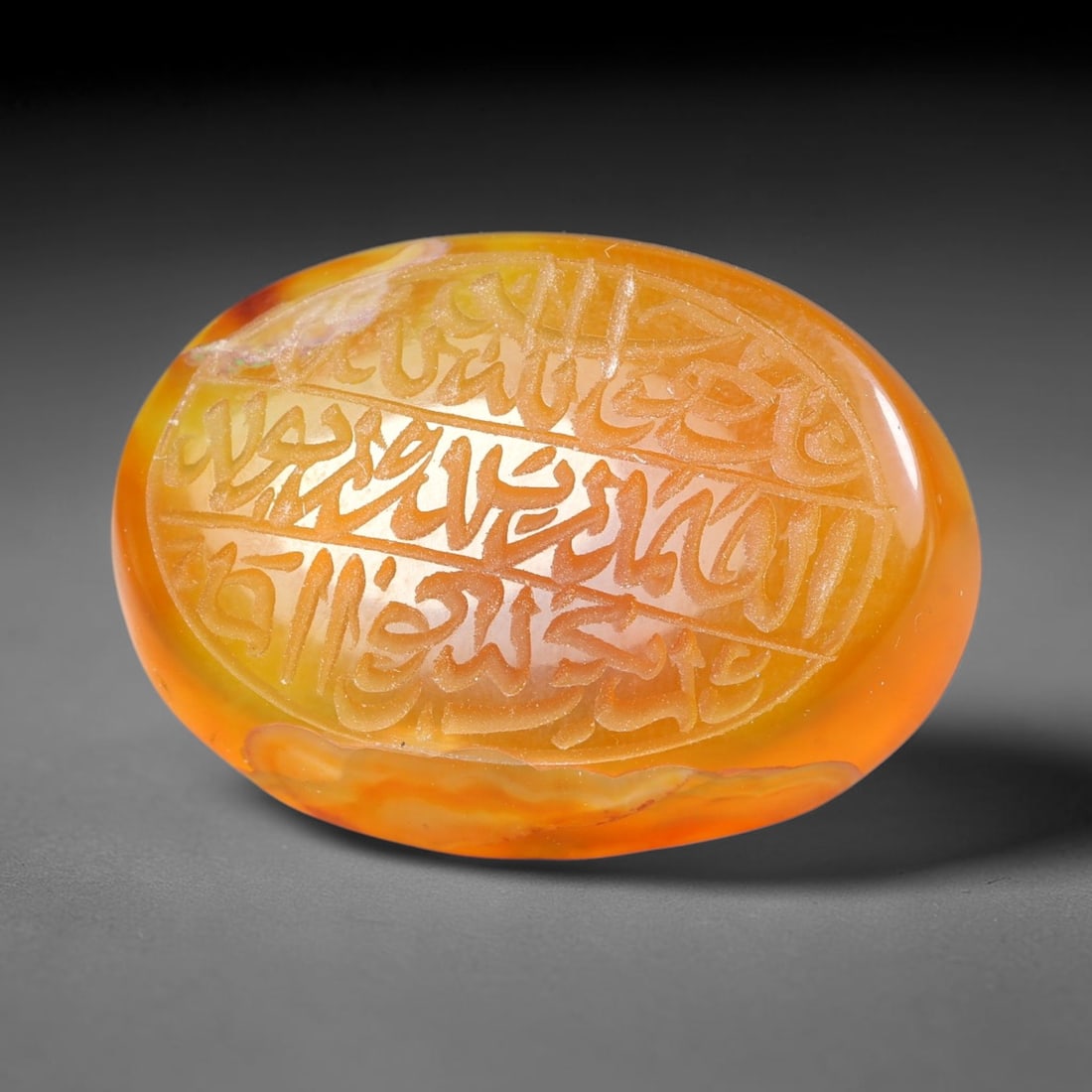 Ancient Medieval Mughal Islamic Carnelian Agate Calligraphic Script Talisman 1526-1857 CE, 48ES: Polished rich-toned carnelian agate cabochon, finely engraved with divided panels of Islamic calligraphic intaglio inscriptions. Deep crisp engraving features segmenting incised lines organizing the s