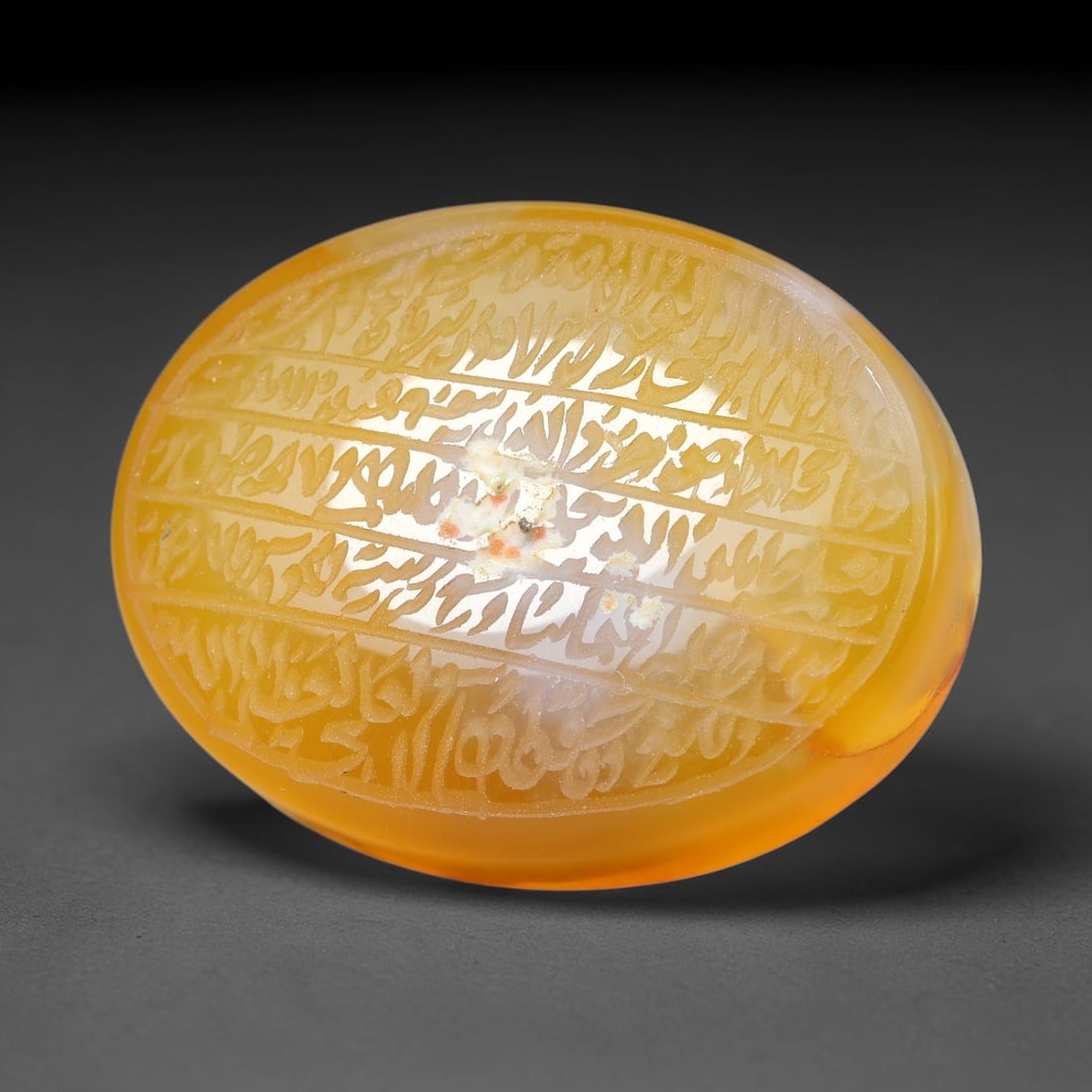 Ancient Medieval Mughal Islamic Carnelian Agate Calligraphic Script Talisman 1526-1857 CE, 6ET: Polished rich-toned carnelian agate cabochon, finely engraved with divided panels of Islamic calligraphic intaglio inscriptions. Deep crisp engraving features segmenting incised lines organizing the s