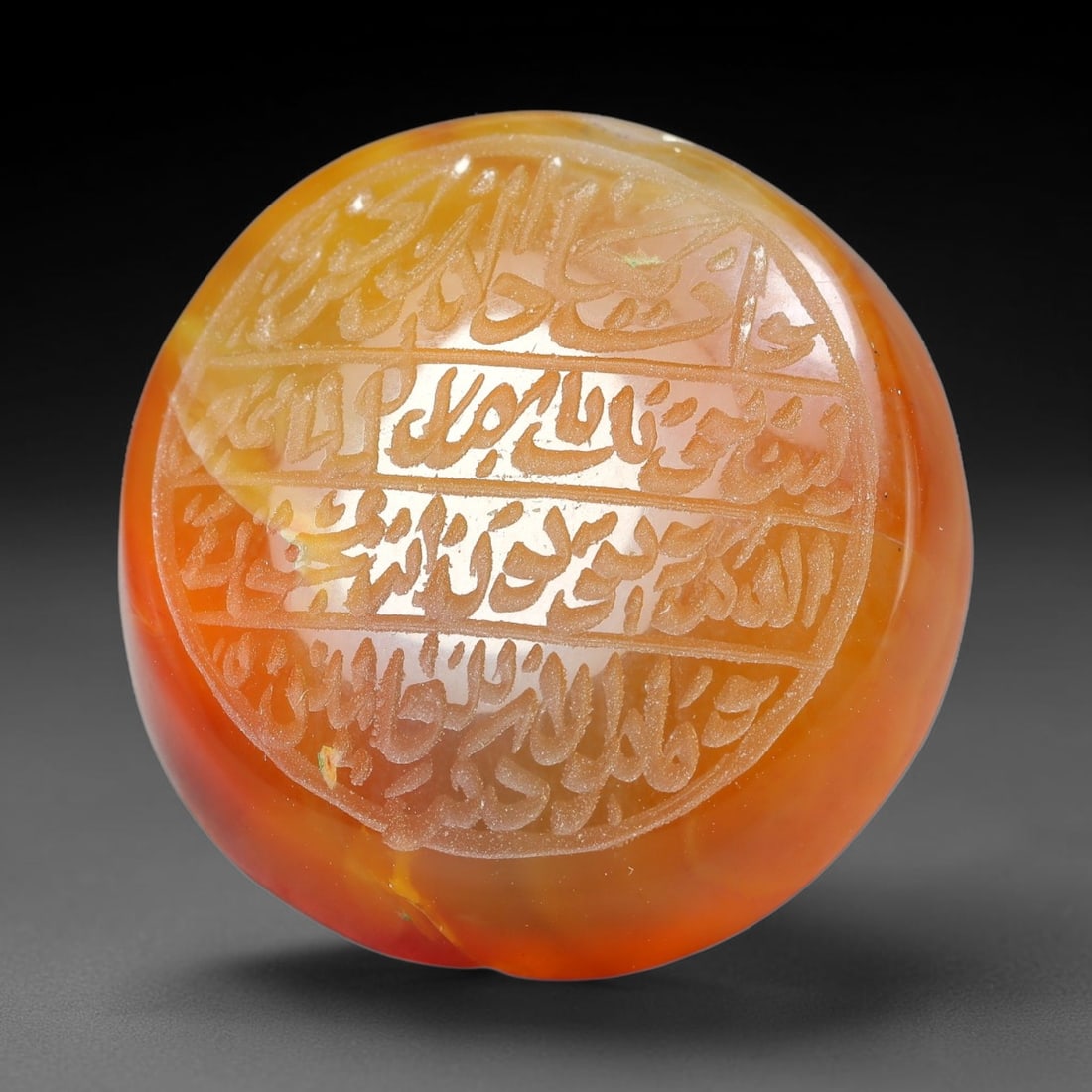 Ancient Medieval Mughal Islamic Carnelian Agate Calligraphic Script Talisman 1526-1857 CE, 21ET: Polished rich-toned carnelian agate cabochon, finely engraved with divided panels of Islamic calligraphic intaglio inscriptions. Deep crisp engraving features segmenting incised lines organizing the s