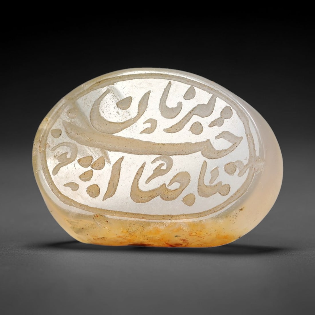 Ancient Medieval Mughal Islamic Carnelian Agate Calligraphic Script Talisman 1526-1857 CE, 38ET: Polished rich-toned carnelian agate cabochon, finely engraved with divided panels of Islamic calligraphic intaglio inscriptions. Deep crisp engraving features segmenting incised lines organizing the s