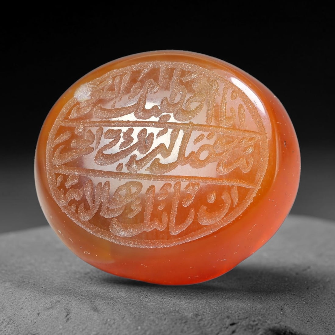 Ancient Medieval Mughal Islamic Carnelian Agate Calligraphic Script Talisman 1526-1857 CE, 35ET: Polished rich-toned carnelian agate cabochon, finely engraved with divided panels of Islamic calligraphic intaglio inscriptions. Deep crisp engraving features segmenting incised lines organizing the s