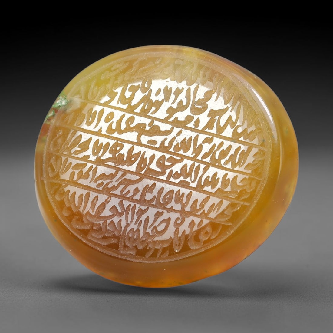 Ancient Medieval Mughal Islamic Carnelian Agate Calligraphic Script Talisman 1526-1857 CE, 84ES: Polished rich-toned carnelian agate cabochon, finely engraved with divided panels of Islamic calligraphic intaglio inscriptions. Deep crisp engraving features segmenting incised lines organizing the s
