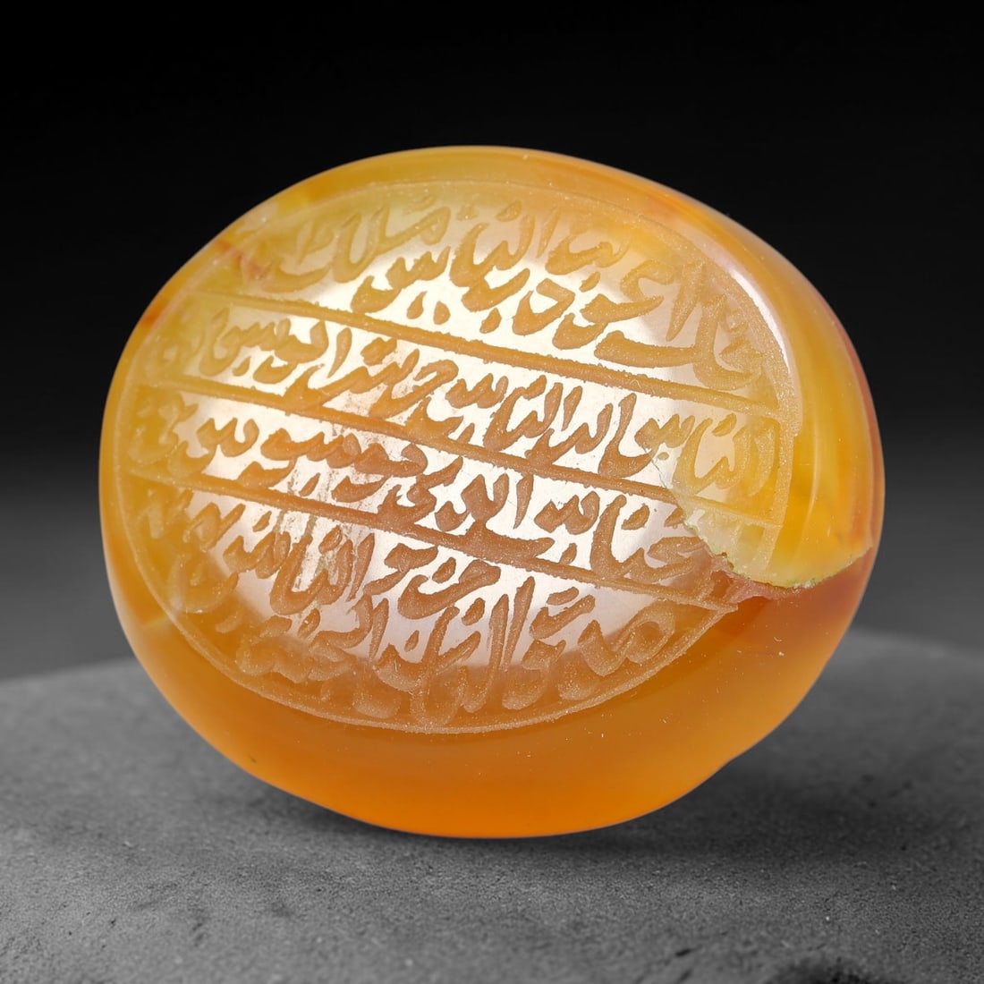 Ancient Medieval Mughal Islamic Carnelian Agate Calligraphic Script Talisman 1526-1857 CE, 10ET: Polished rich-toned carnelian agate cabochon, finely engraved with divided panels of Islamic calligraphic intaglio inscriptions. Deep crisp engraving features segmenting incised lines organizing the s