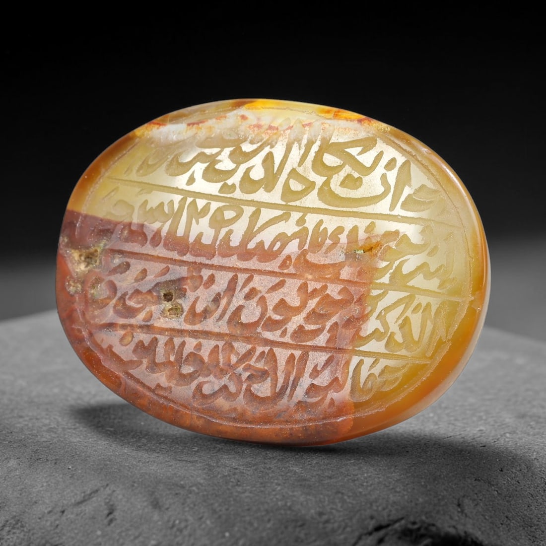 Ancient Medieval Mughal Islamic Carnelian Agate Calligraphic Script Talisman 1526-1857 CE, 81ES: Polished rich-toned carnelian agate cabochon, finely engraved with divided panels of Islamic calligraphic intaglio inscriptions. Deep crisp engraving features segmenting incised lines organizing the s