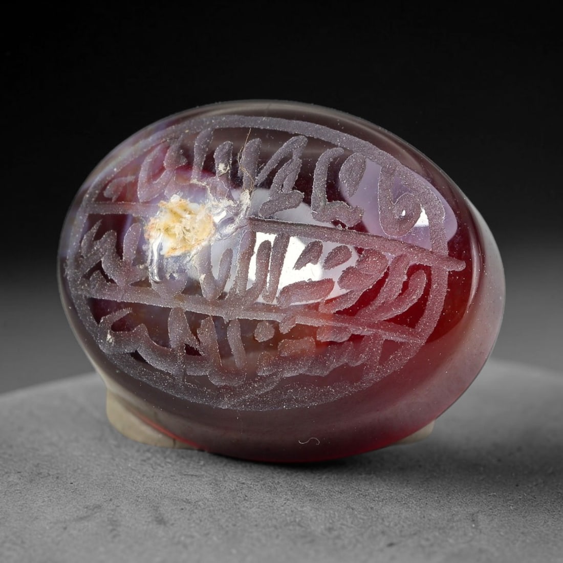 Ancient Medieval Mughal Islamic Carnelian Agate Calligraphic Script Talisman 1526-1857 CE, 25ET: Polished rich-toned carnelian agate cabochon, finely engraved with divided panels of Islamic calligraphic intaglio inscriptions. Deep crisp engraving features segmenting incised lines organizing the s