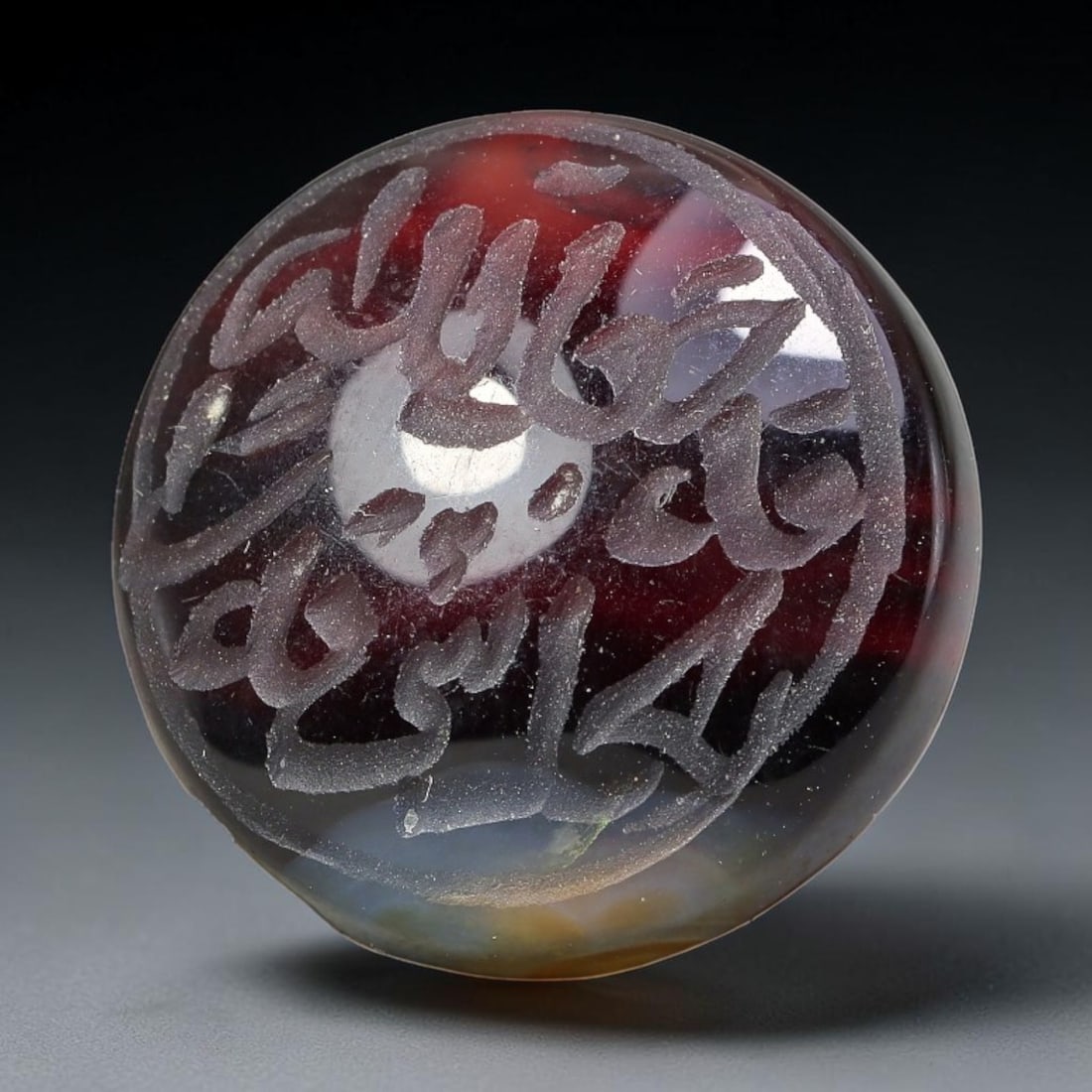 Ancient Medieval Mughal Islamic Carnelian Agate Calligraphic Script Talisman 1526-1857 CE, 44ET: Polished rich-toned carnelian agate cabochon, finely engraved with divided panels of Islamic calligraphic intaglio inscriptions. Deep crisp engraving features segmenting incised lines organizing the s