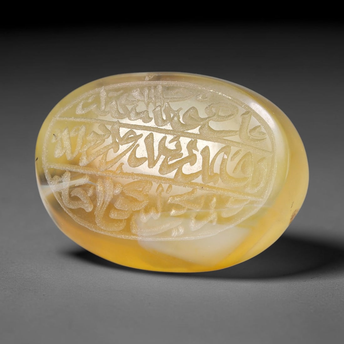 Ancient Medieval Mughal Islamic Carnelian Agate Calligraphic Script Talisman 1526-1857 CE, 28ET: Polished rich-toned carnelian agate cabochon, finely engraved with divided panels of Islamic calligraphic intaglio inscriptions. Deep crisp engraving features segmenting incised lines organizing the s