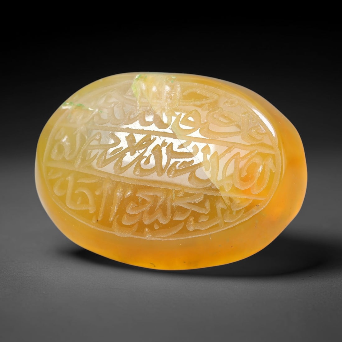 Ancient Medieval Mughal Islamic Carnelian Agate Calligraphic Script Talisman 1526-1857 CE, 9ET: Polished rich-toned carnelian agate cabochon, finely engraved with divided panels of Islamic calligraphic intaglio inscriptions. Deep crisp engraving features segmenting incised lines organizing the s