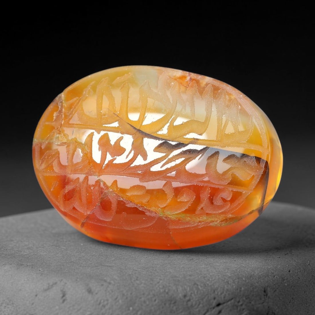 Ancient Medieval Mughal Islamic Carnelian Agate Calligraphic Script Talisman 1526-1857 CE, 18ET: Polished rich-toned carnelian agate cabochon, finely engraved with divided panels of Islamic calligraphic intaglio inscriptions. Deep crisp engraving features segmenting incised lines organizing the s