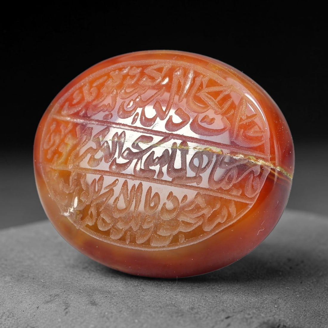 Ancient Medieval Mughal Islamic Carnelian Agate Calligraphic Script Talisman 1526-1857 CE, 17ET: Polished rich-toned carnelian agate cabochon, finely engraved with divided panels of Islamic calligraphic intaglio inscriptions. Deep crisp engraving features segmenting incised lines organizing the s